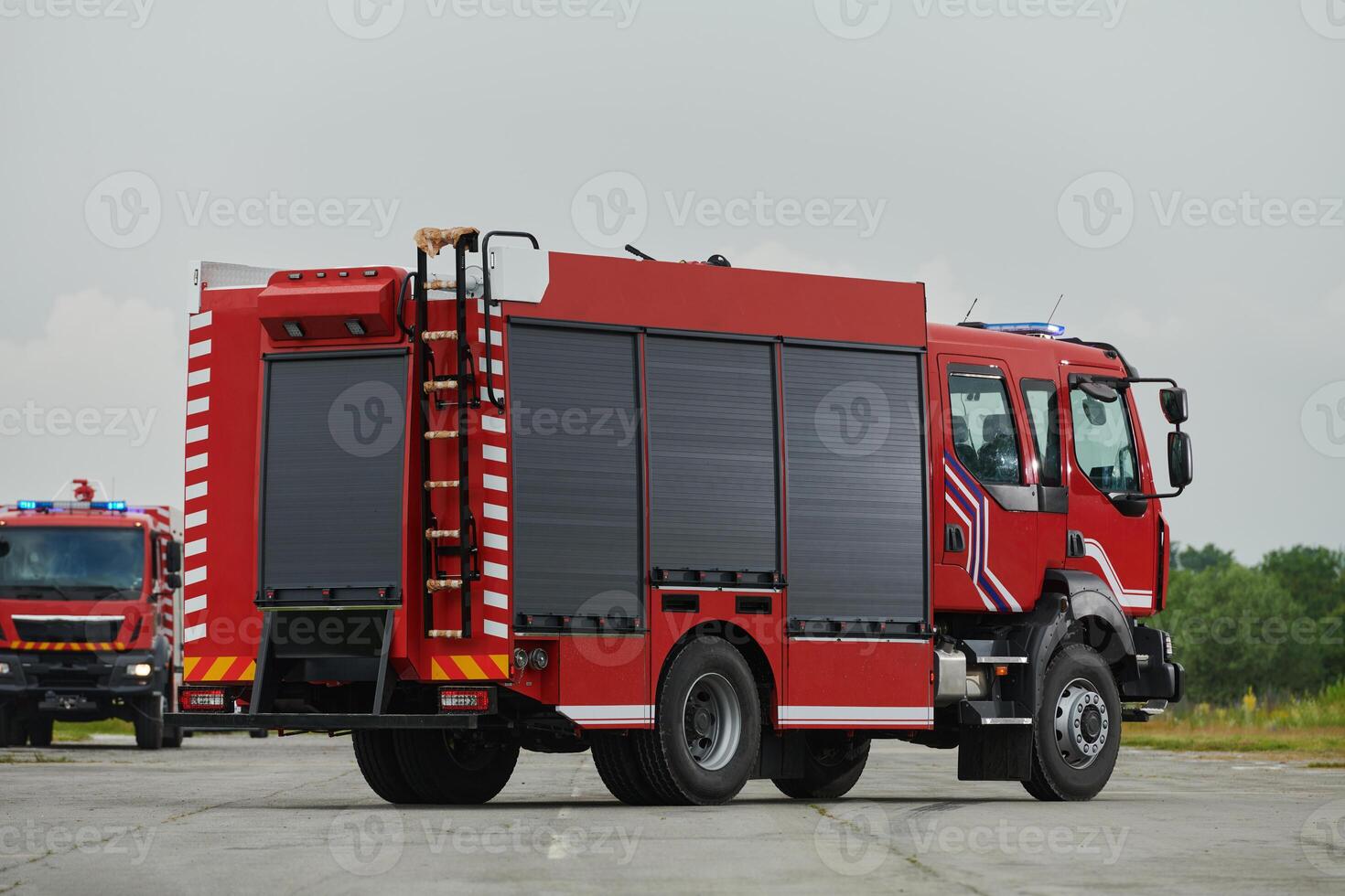 In this captivating scene, a state-of-the-art firetruck, equipped with advanced rescue technology, stands ready with its skilled firefighting team, prepared to intervene and respond rapidly to photo