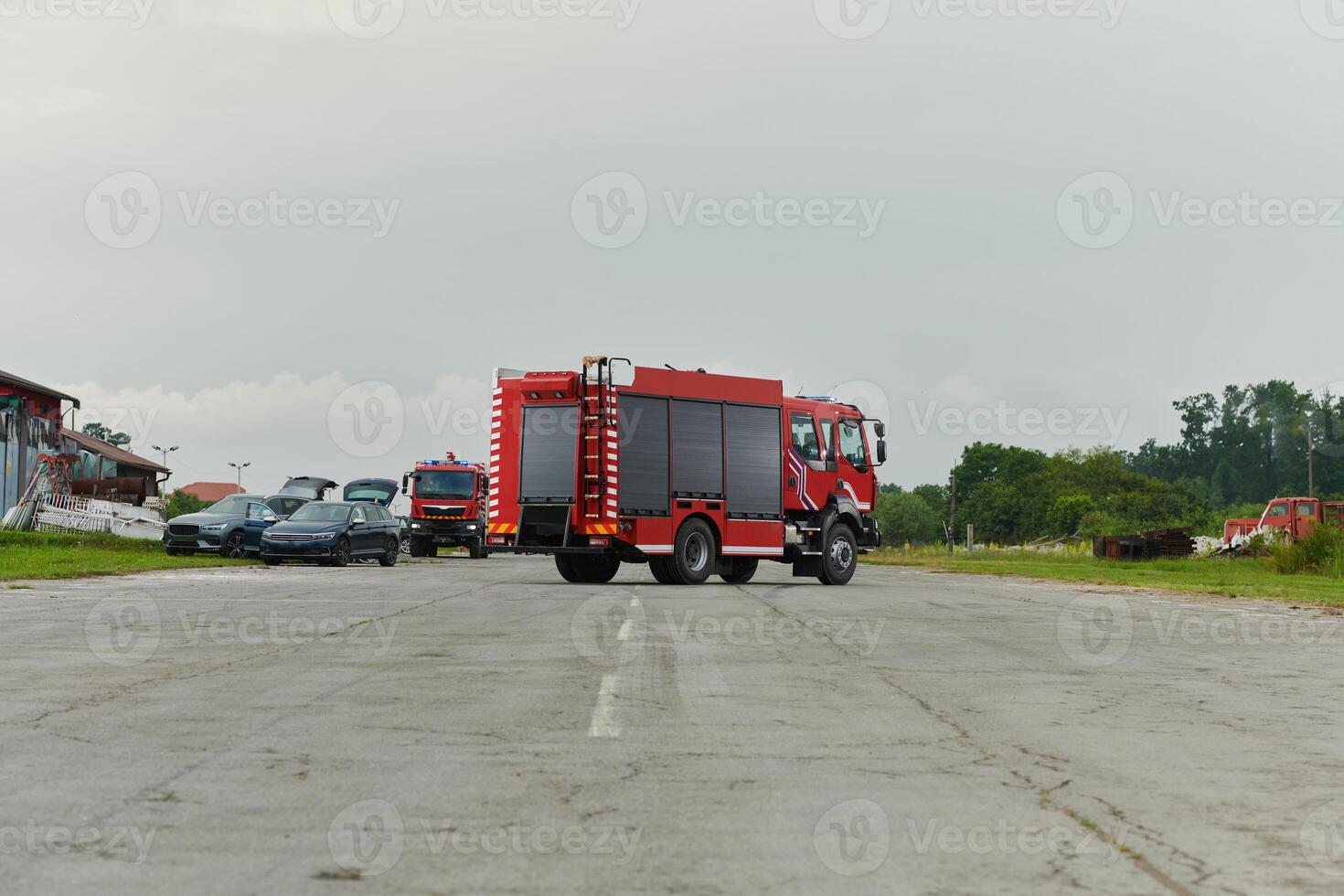 In this captivating scene, a state-of-the-art firetruck, equipped with advanced rescue technology, stands ready with its skilled firefighting team, prepared to intervene and respond rapidly to photo