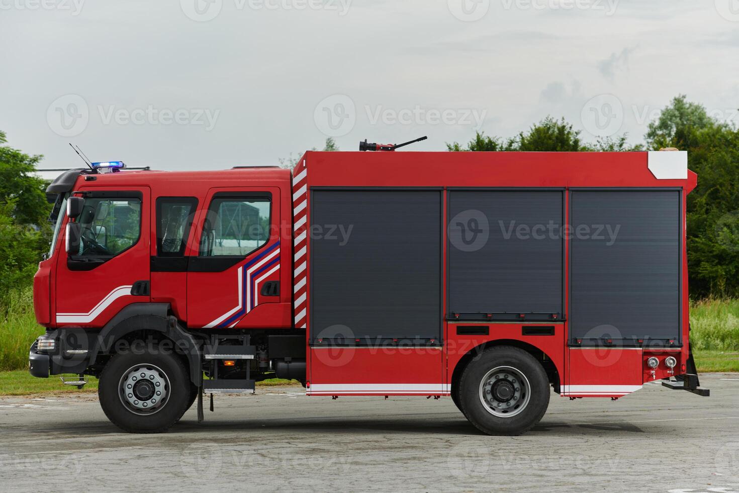 In this captivating scene, a state-of-the-art firetruck, equipped with advanced rescue technology, stands ready with its skilled firefighting team, prepared to intervene and respond rapidly to photo