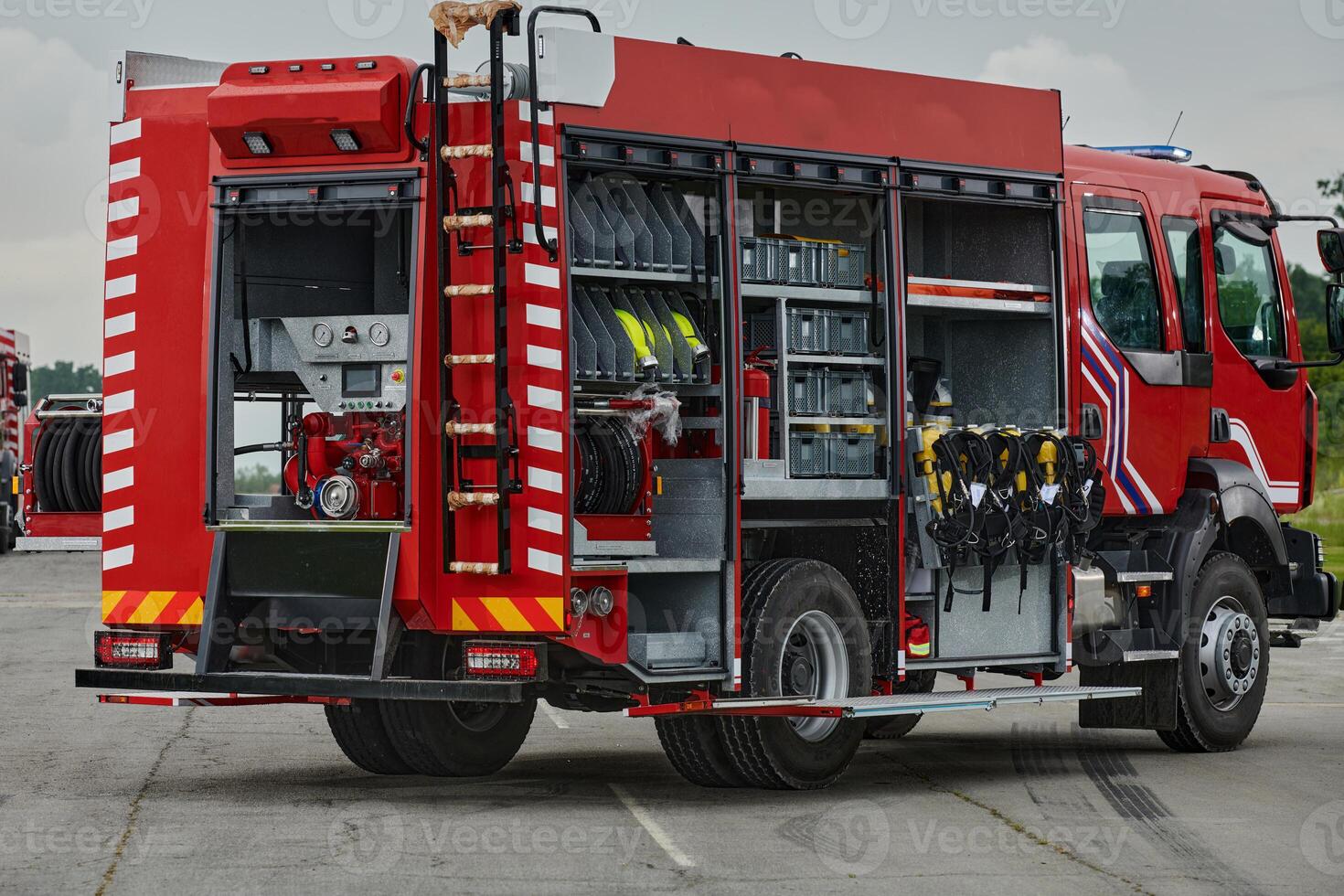 In this captivating scene, a state-of-the-art firetruck, equipped with advanced rescue technology, stands ready with its skilled firefighting team, prepared to intervene and respond rapidly to photo