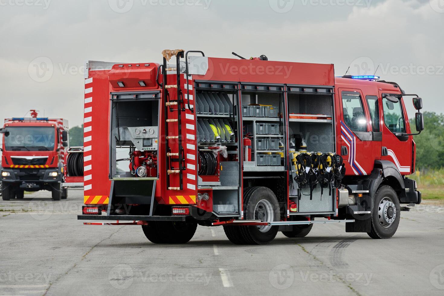 In this captivating scene, a state-of-the-art firetruck, equipped with advanced rescue technology, stands ready with its skilled firefighting team, prepared to intervene and respond rapidly to photo