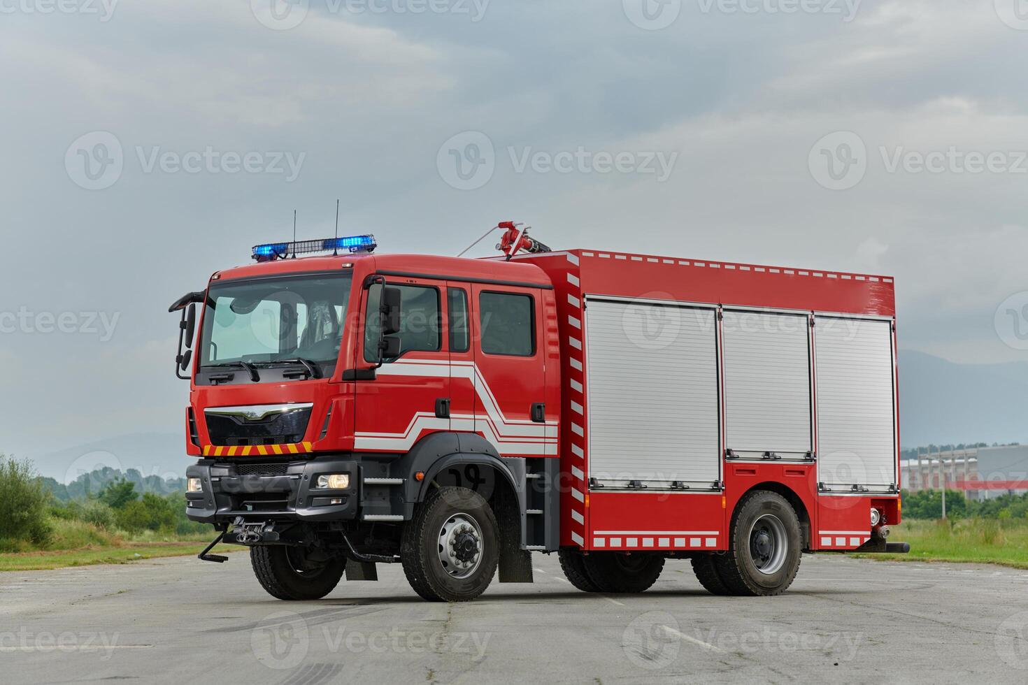 In this captivating scene, a state-of-the-art firetruck, equipped with advanced rescue technology, stands ready with its skilled firefighting team, prepared to intervene and respond rapidly to photo