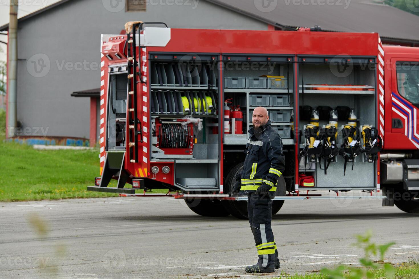 A firefighter meticulously prepares a modern firetruck for a mission to evacuate and respond to dangerous situations, showcasing the utmost dedication to safety and readiness in the face of a fire photo