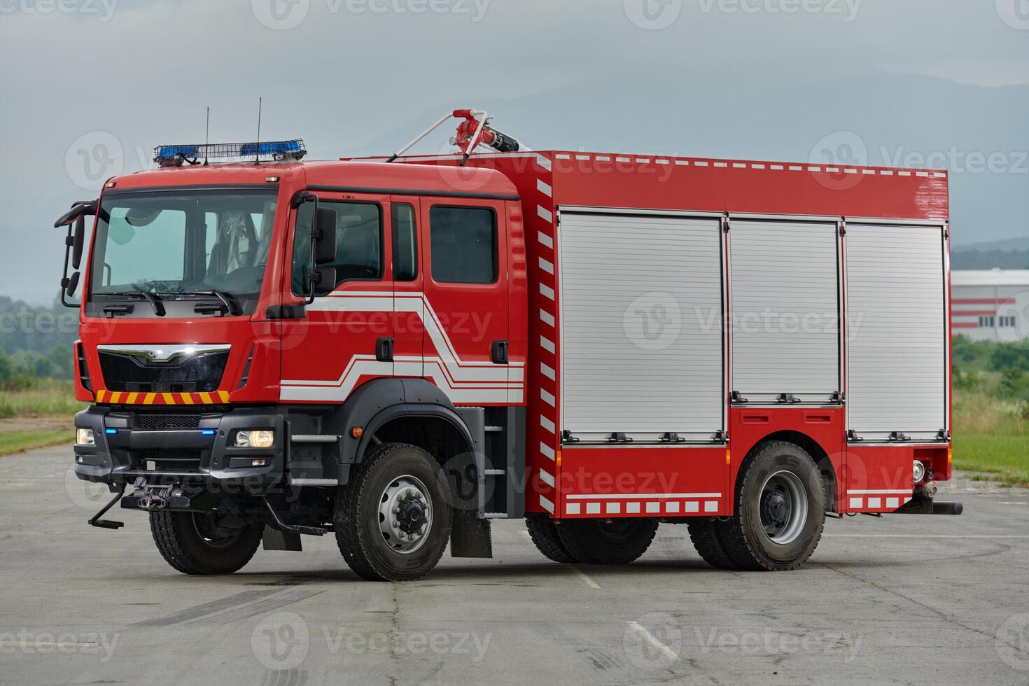 In this captivating scene, a state-of-the-art firetruck, equipped with advanced rescue technology, stands ready with its skilled firefighting team, prepared to intervene and respond rapidly to photo