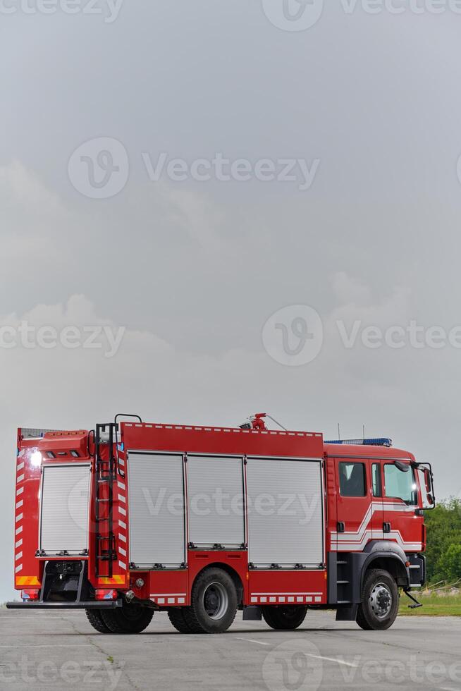 In this captivating scene, a state-of-the-art firetruck, equipped with advanced rescue technology, stands ready with its skilled firefighting team, prepared to intervene and respond rapidly to photo