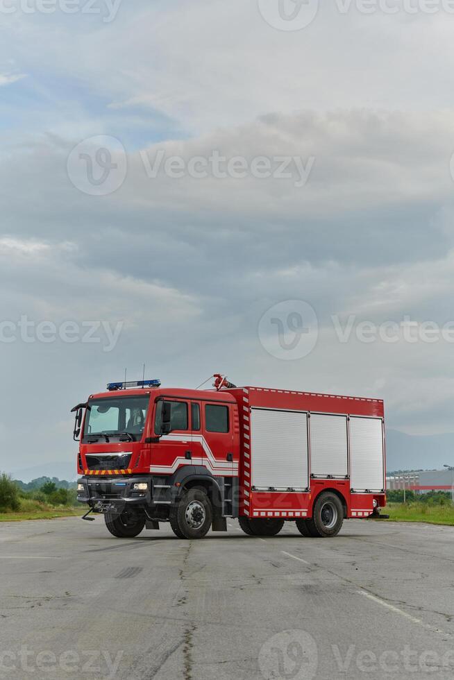 In this captivating scene, a state-of-the-art firetruck, equipped with advanced rescue technology, stands ready with its skilled firefighting team, prepared to intervene and respond rapidly to photo