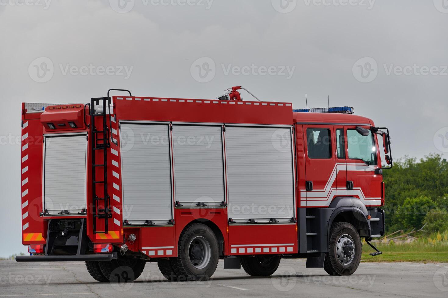 In this captivating scene, a state-of-the-art firetruck, equipped with advanced rescue technology, stands ready with its skilled firefighting team, prepared to intervene and respond rapidly to photo