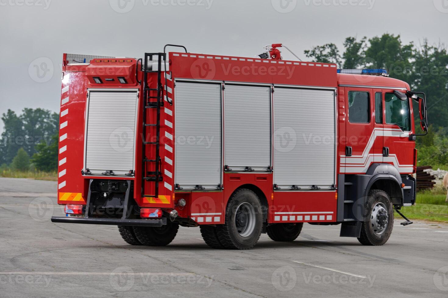 In this captivating scene, a state-of-the-art firetruck, equipped with advanced rescue technology, stands ready with its skilled firefighting team, prepared to intervene and respond rapidly to photo