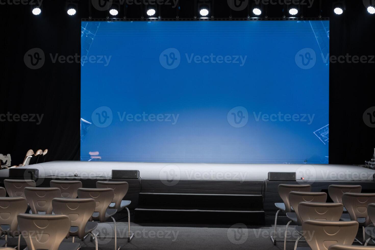 empty conference stage and a blank blue screen photo