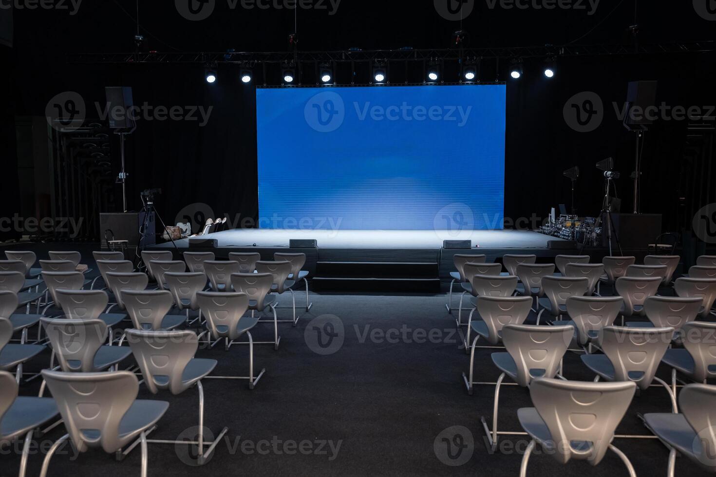 empty conference stage and a blank blue screen photo