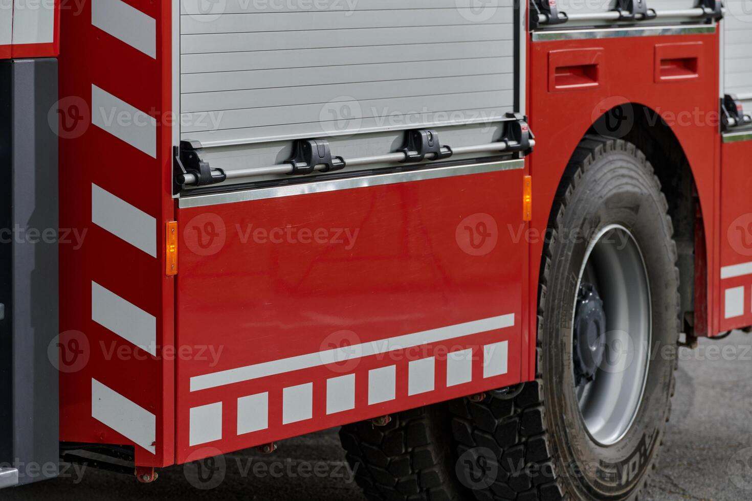 In this captivating scene, a state-of-the-art firetruck, equipped with advanced rescue technology, stands ready with its skilled firefighting team, prepared to intervene and respond rapidly to photo