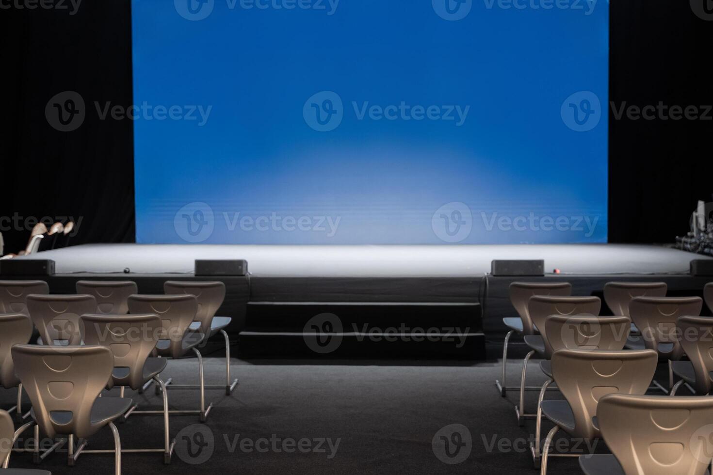 empty conference stage and a blank blue screen photo