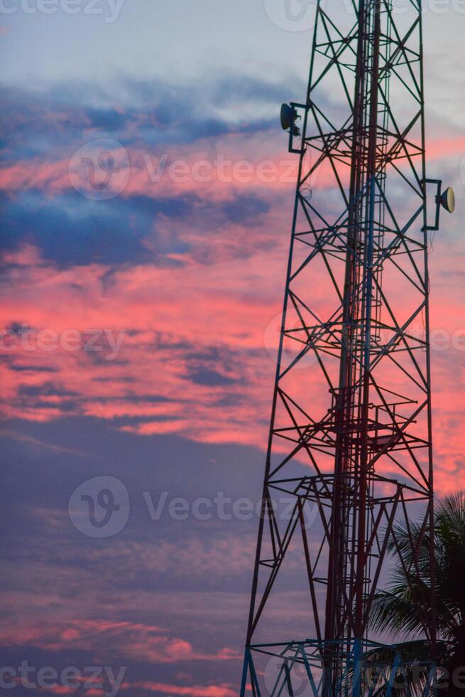 a tower with a cell phone on top of it photo