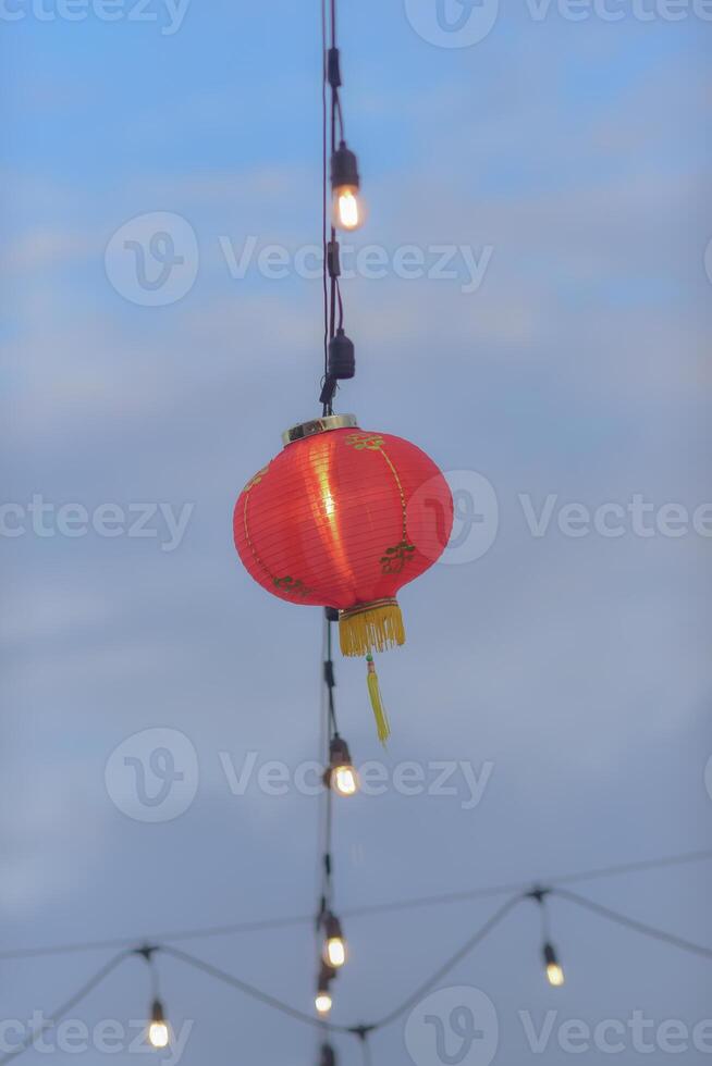 a red lantern hanging from a string photo