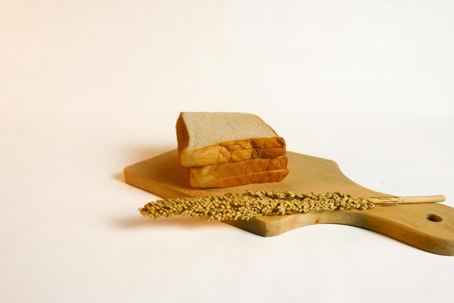 photography of bread with wheat on a white background photo