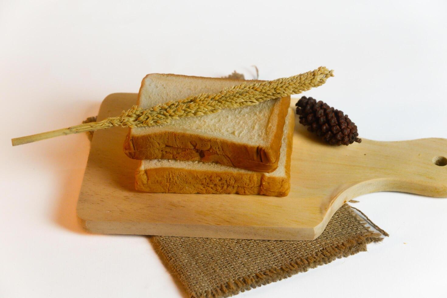 photography of bread with wheat on a white background photo
