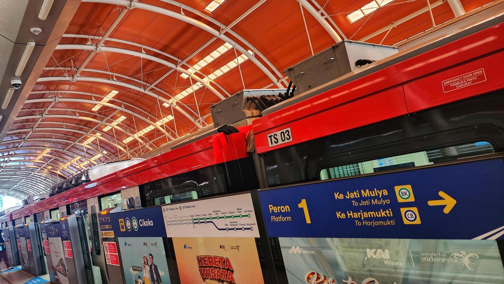 a red and white train is parked at a station photo