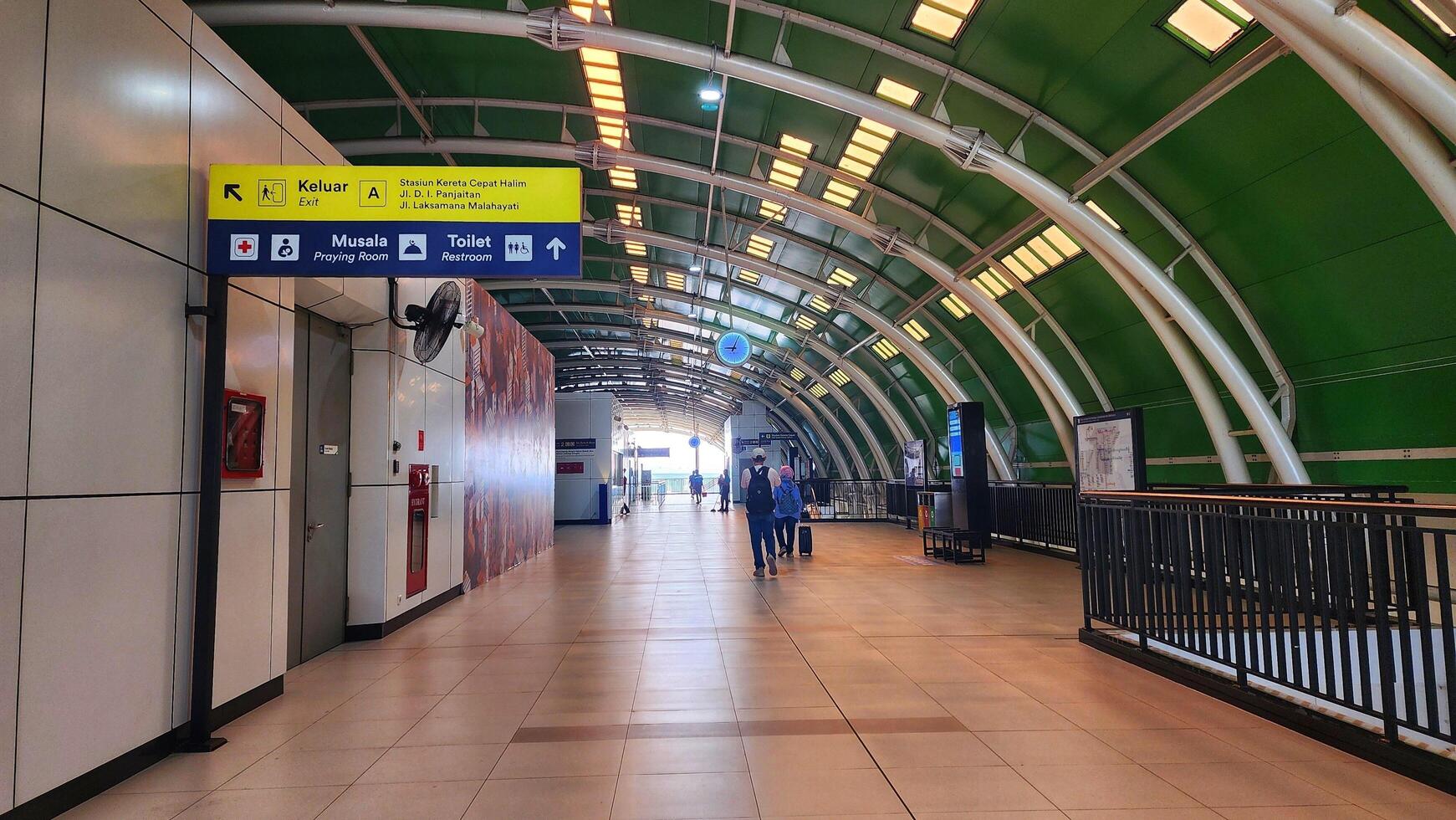 the inside of an airport with a green roof photo