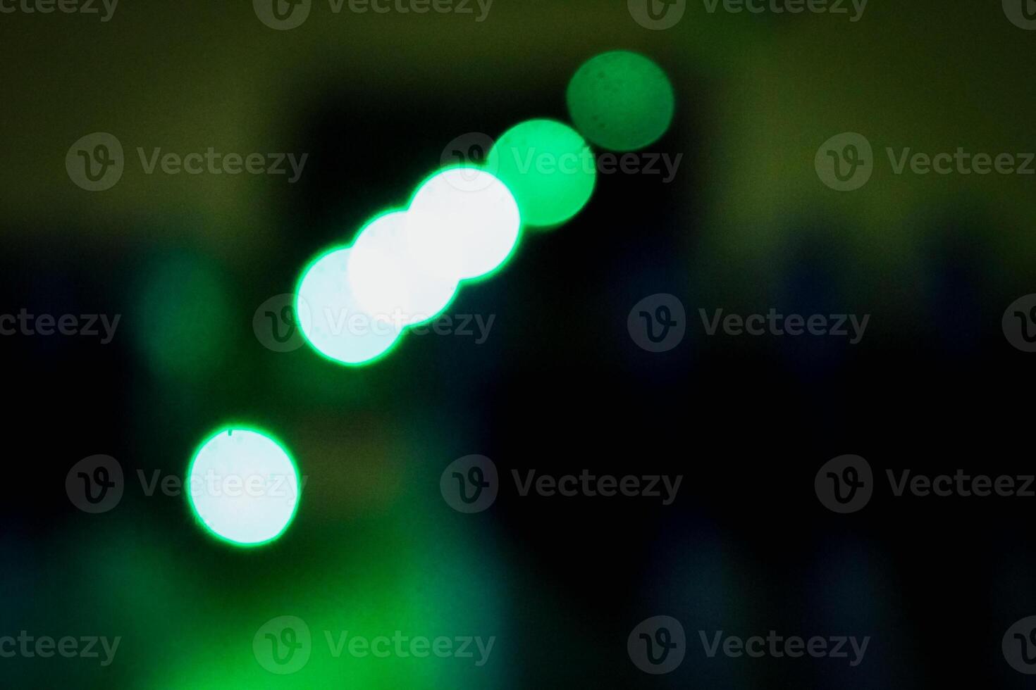 Defocused abstract background of green light in the night photo