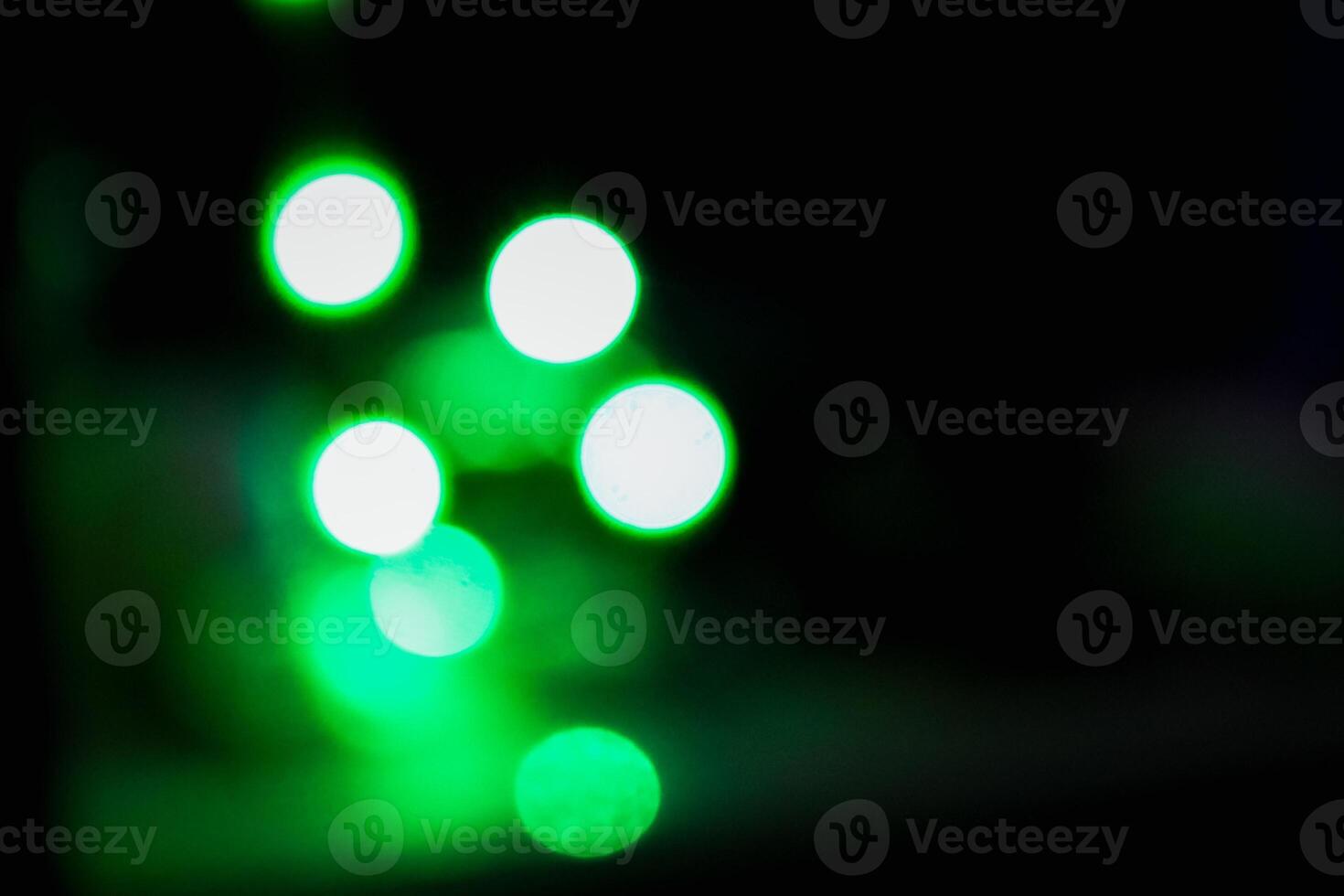 Defocused abstract background of green light in the night photo