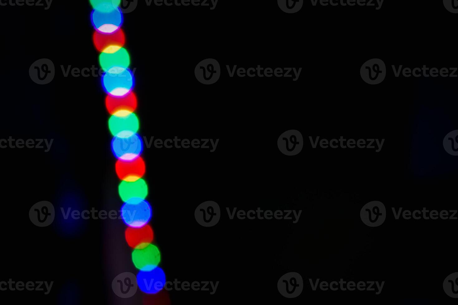 Defocused abstract background of red, blue, and green light in the night photo