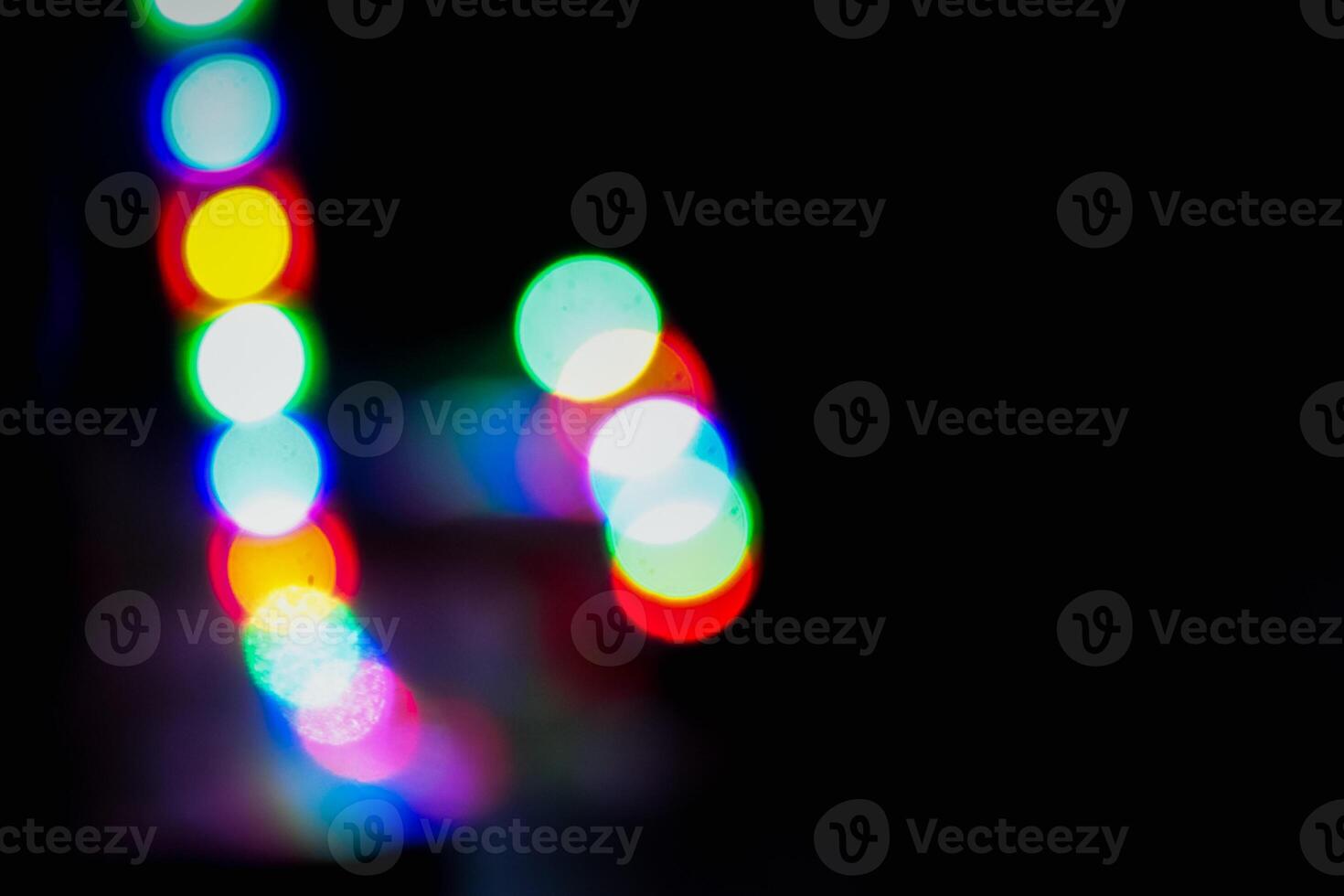 Defocused abstract background of red, blue, and green light in the night photo