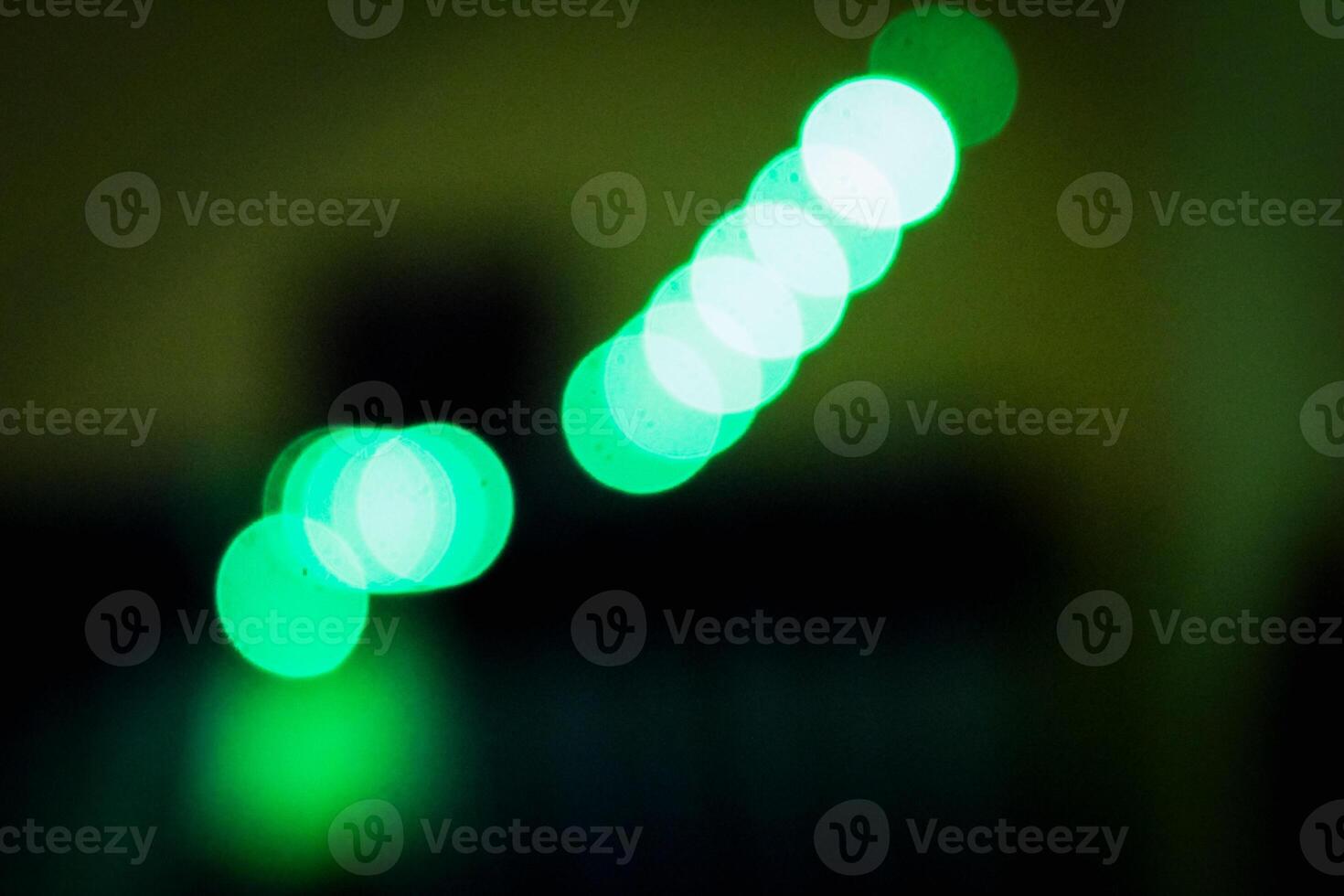 Defocused abstract background of green light in the night photo