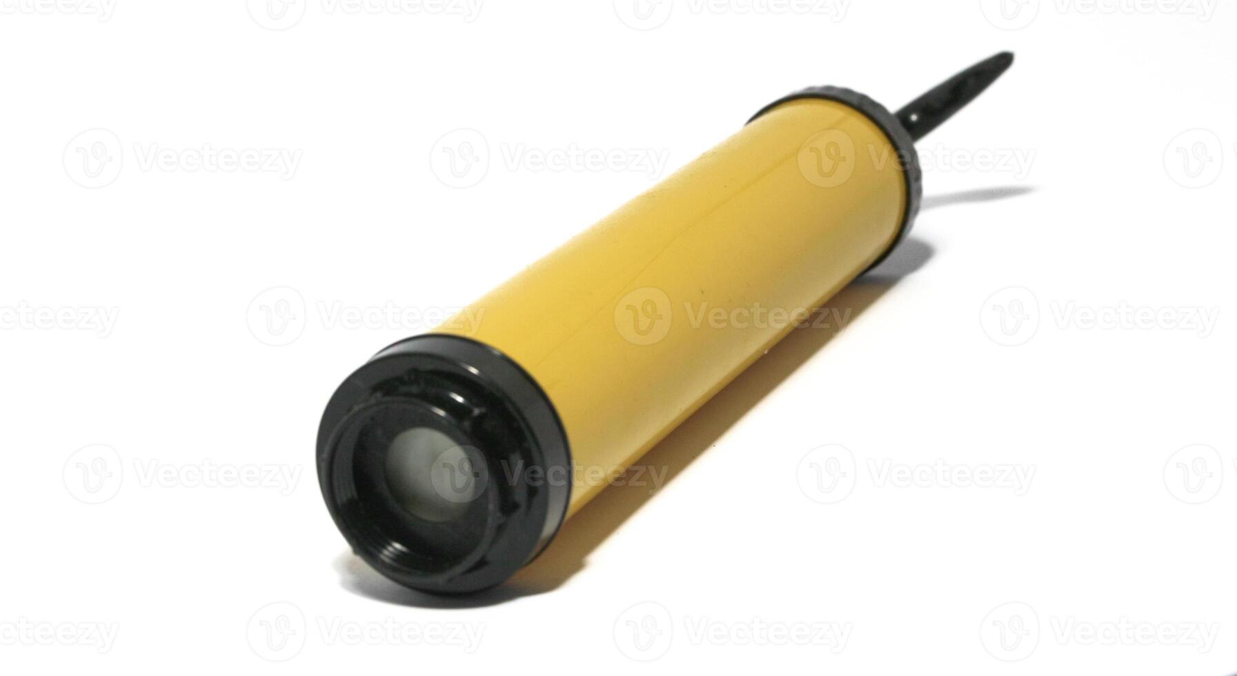 Yellow manual plastic vacuum pump isolated on white, the vacuum pump saves space in the trunk photo