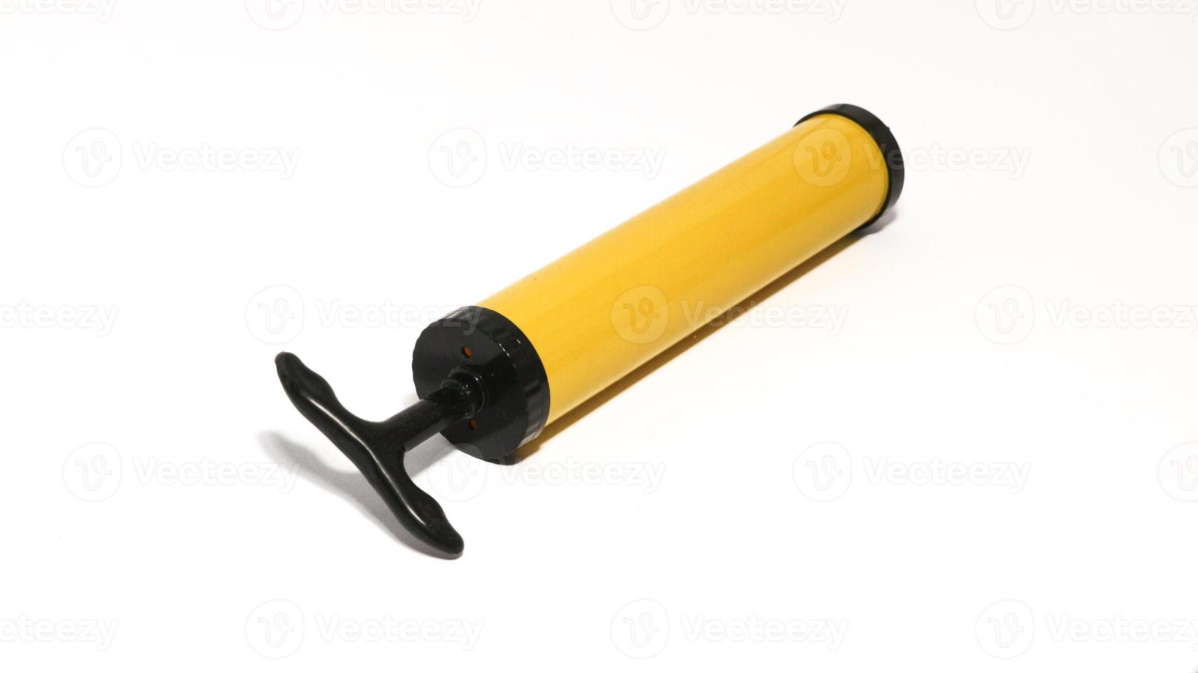 Yellow manual plastic vacuum pump isolated on white, the vacuum pump saves space in the trunk photo