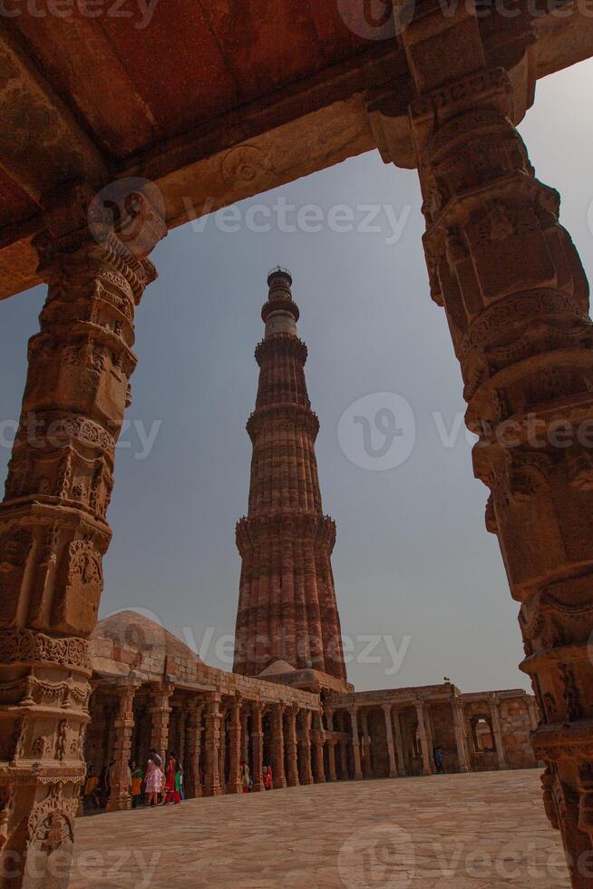 The ancient tower is made of red bricks. Taking photos under the walkway roof