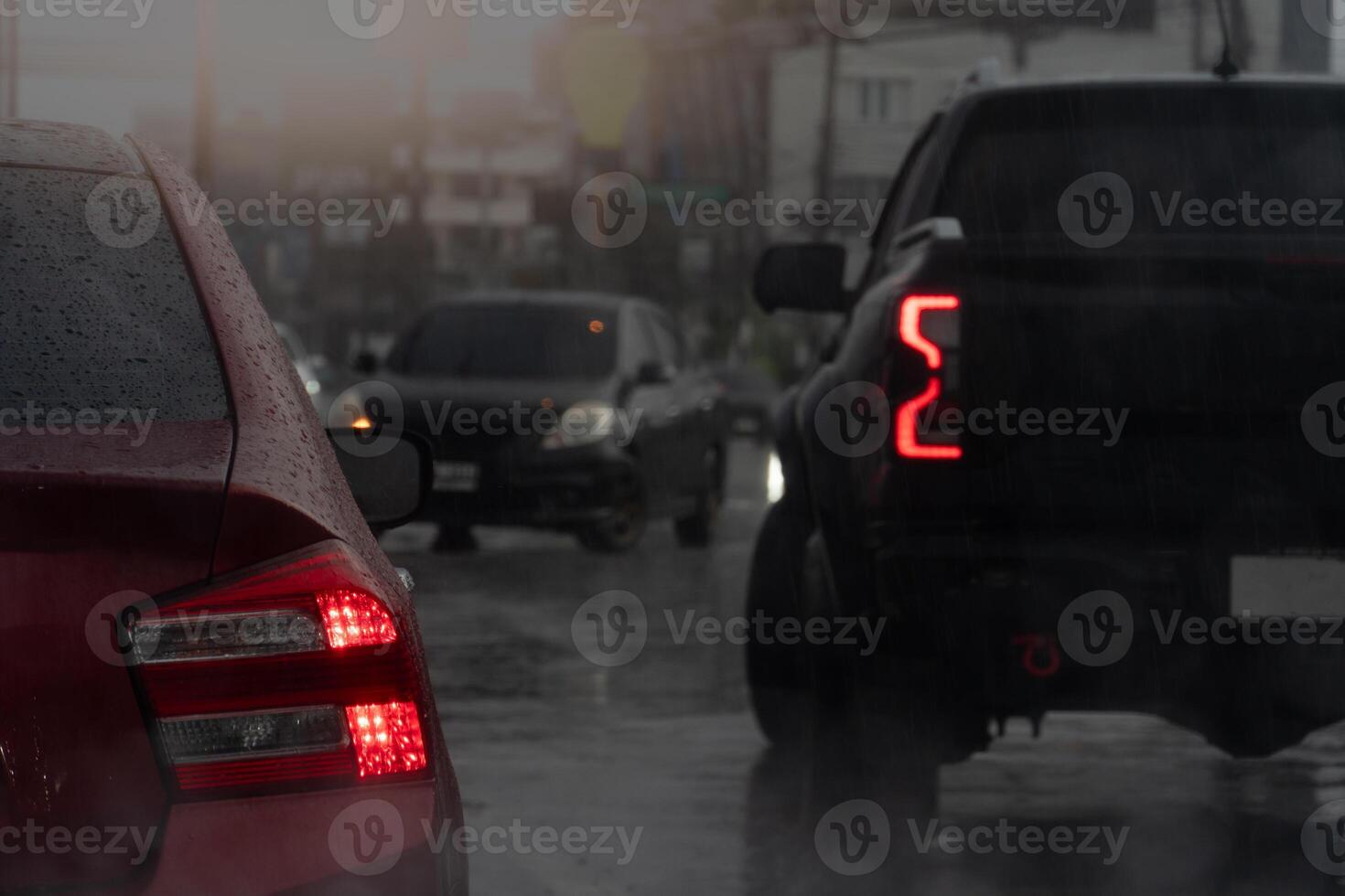 Transporting cars on the road. Turn on your brake lights and wait for the car in front to make a U-turn. All cars are wet from the rain. The atmosphere is heavy rain and gloomy lights. photo
