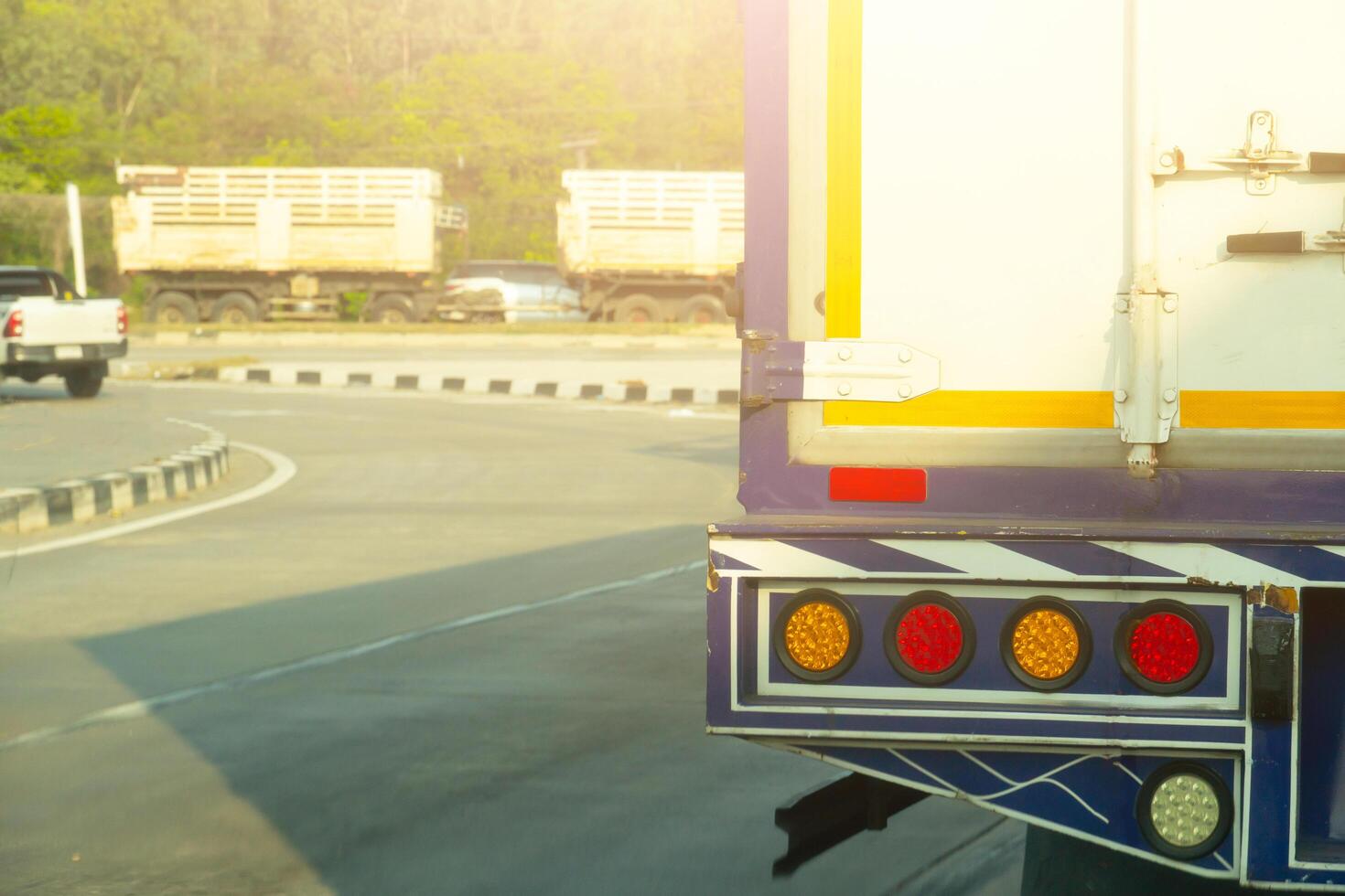 Transportation of truck car driving on the road. Beside road curved path of asphalt road and other cars photo