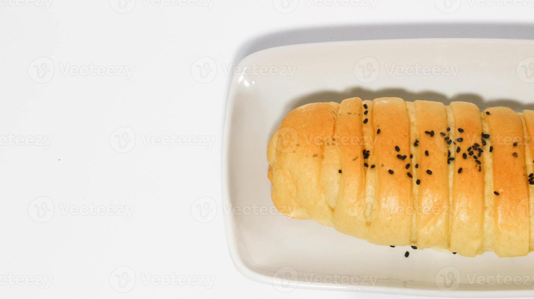 Traditional Indonesian snack called, chocolate banana bread which is bread filled with banana and chocolate jam served on a plate isolated on a white background photo