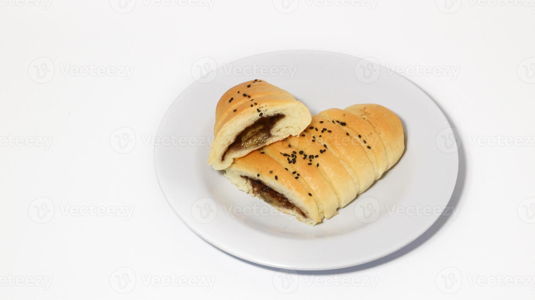 Traditional Indonesian snack called, chocolate banana bread which is bread filled with banana and chocolate jam served on a plate isolated on a white background photo