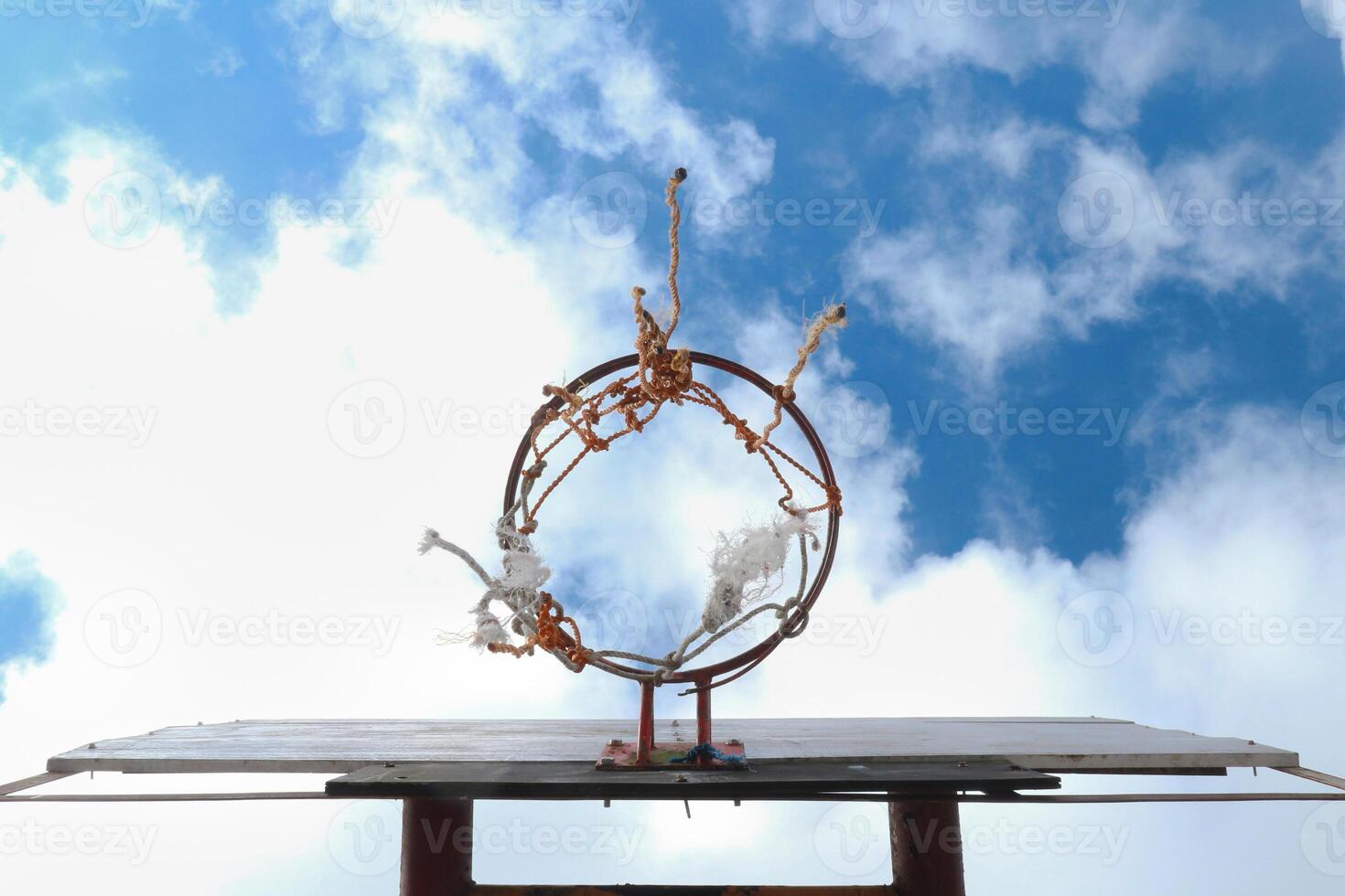 View of an old basketball hoop in the sky from a low angle photo