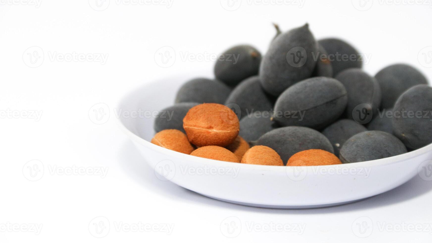 Kranji Tamarind Fruit, Dialium indum, the tamarind-plum, is a tall, tropical, fruit-bearing tree. It belongs to the family Fabaceae, and has small, typically grape-sized edible fruits. photo