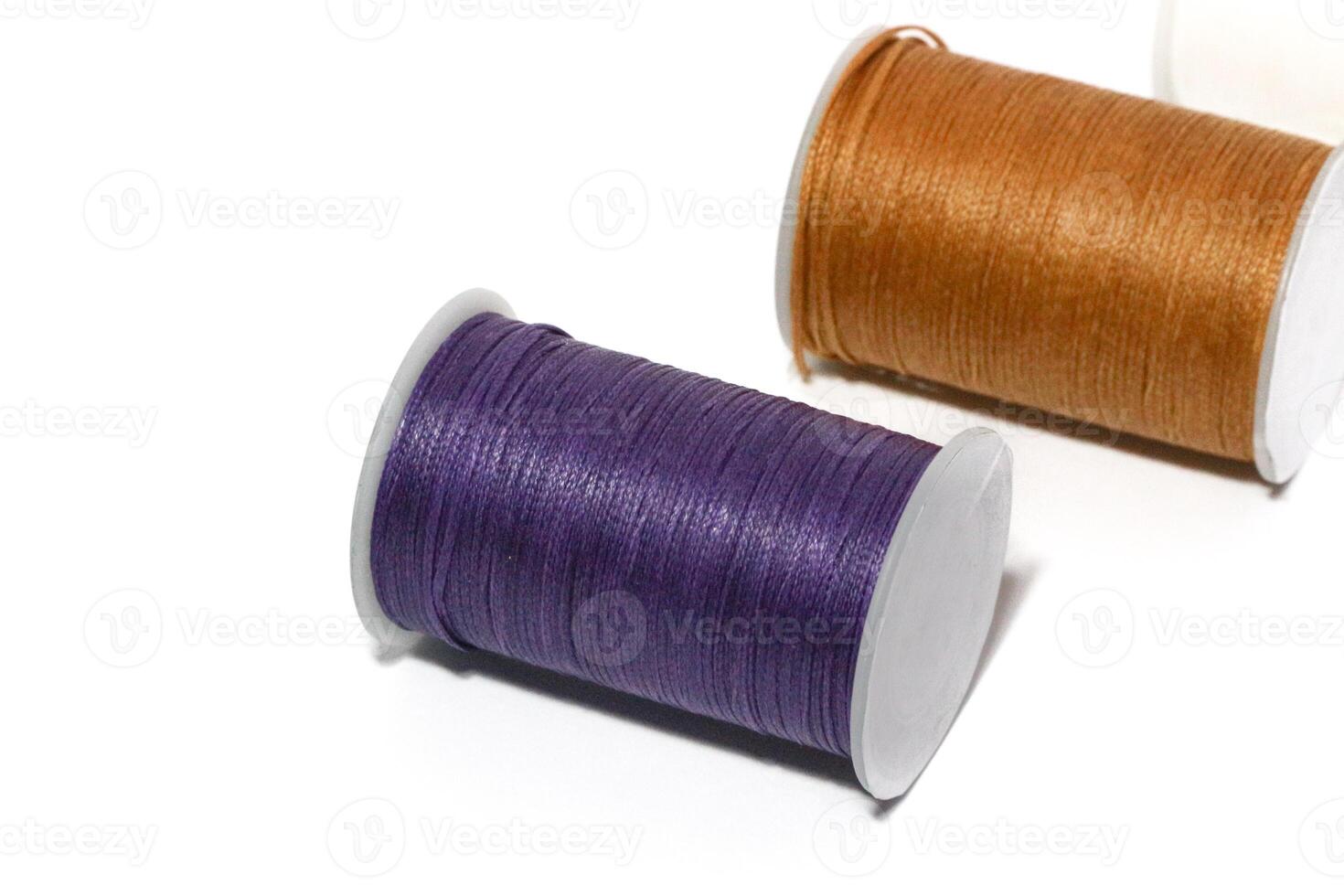 Spool of sewing thread, isolated on white background. Colored yarns used by factories in the clothing industry. Threads wound on the spool. Colored reels photo