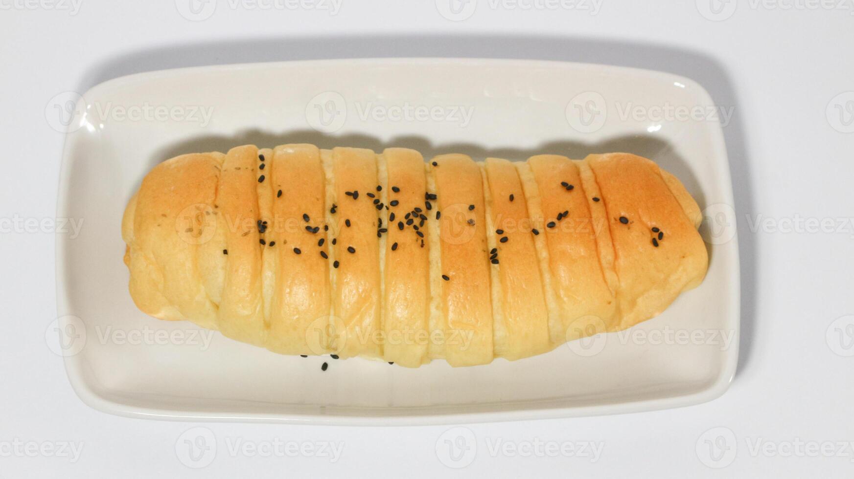 Traditional Indonesian snack called, chocolate banana bread which is bread filled with banana and chocolate jam served on a plate isolated on a white background photo