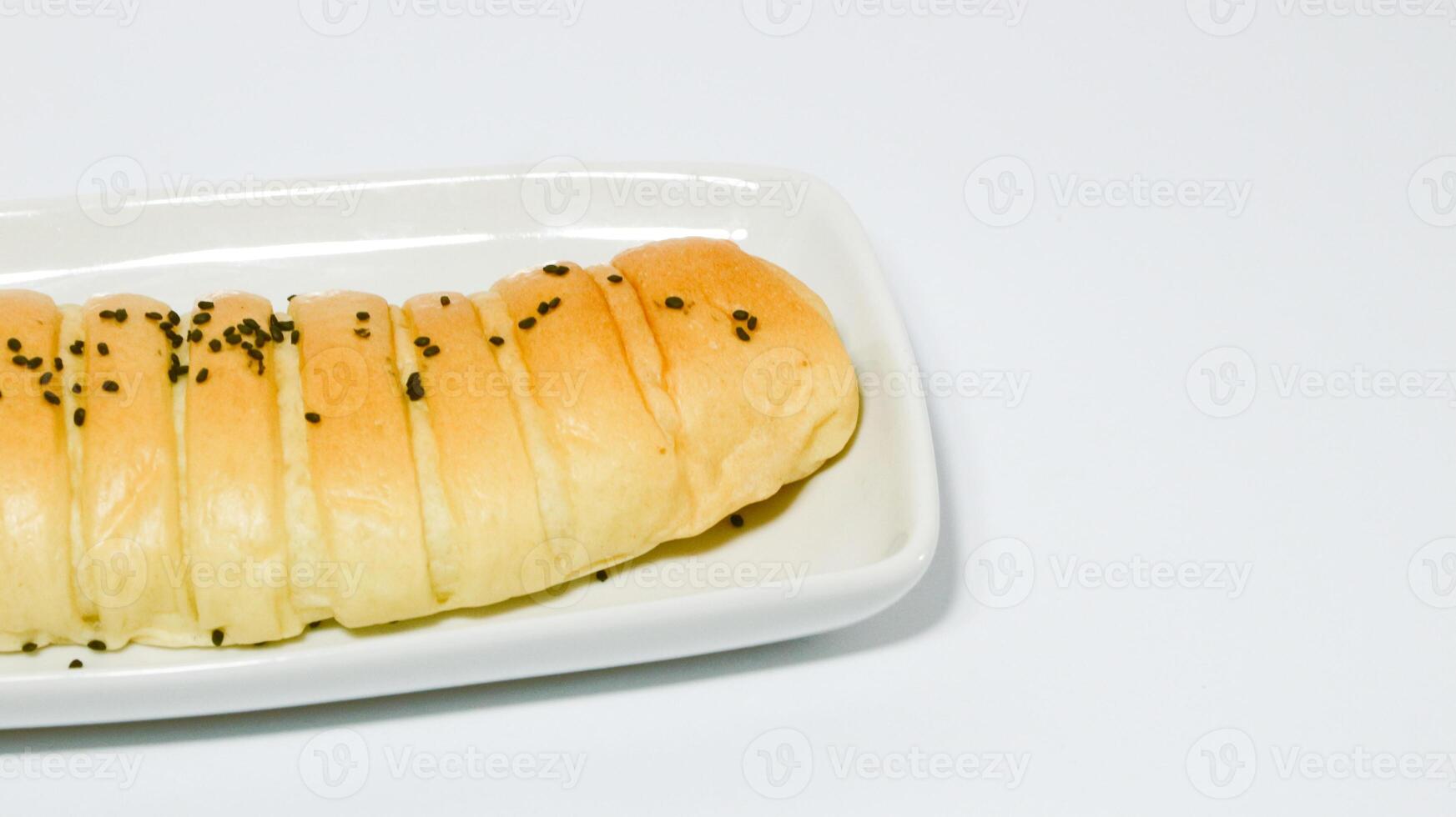 Traditional Indonesian snack called, chocolate banana bread which is bread filled with banana and chocolate jam served on a plate isolated on a white background photo