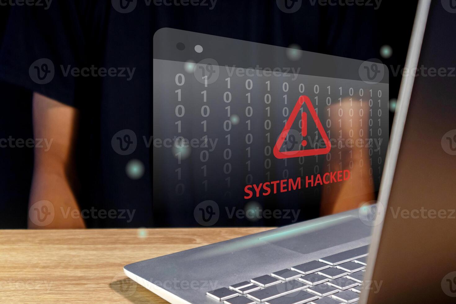 Hacker or cyber criminal with laptop stealing user personal data. Warning of a system hacked. Virus, malware or cyber attack. photo