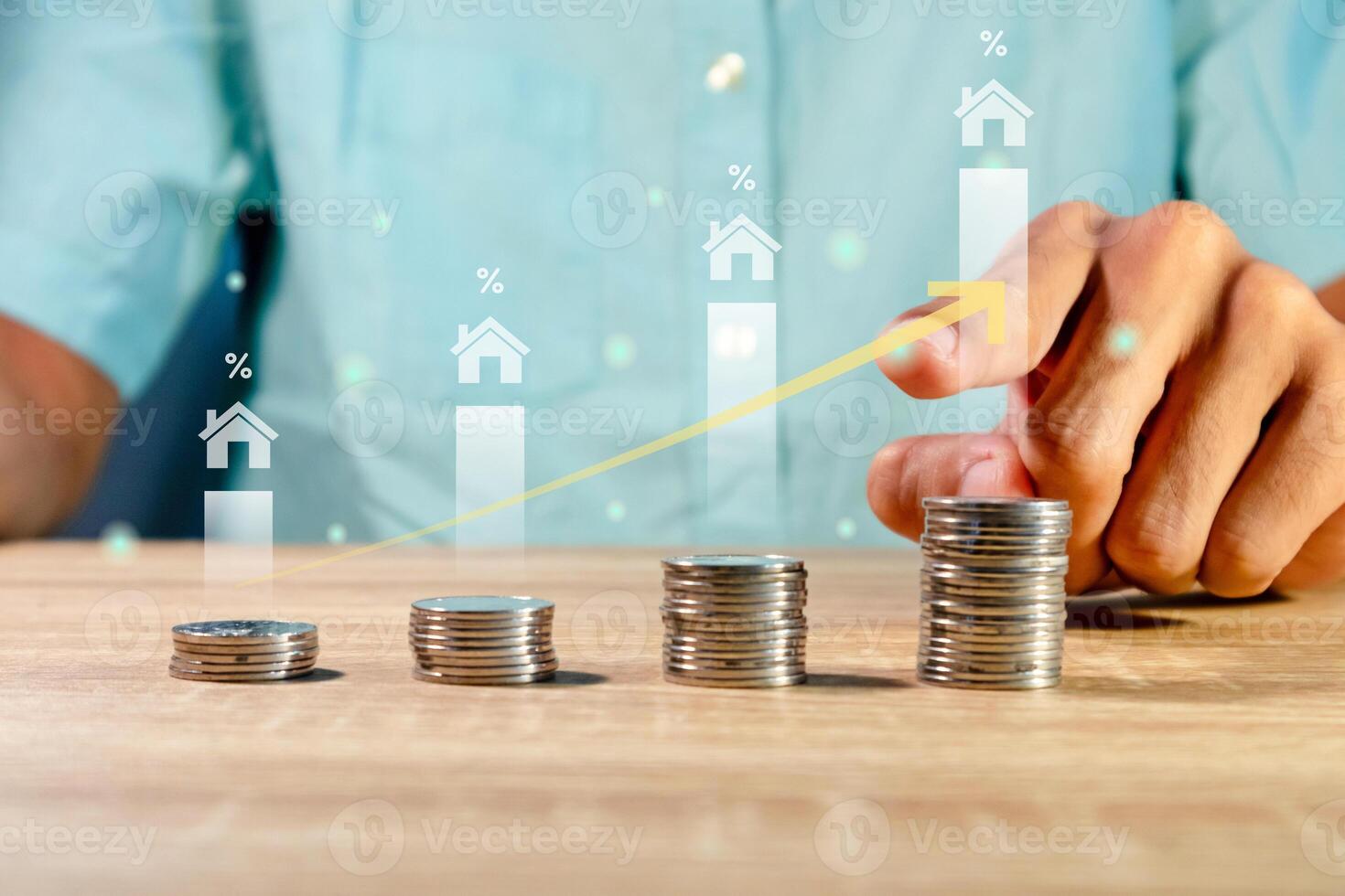 Man with coins on the table. House price rising up or real estate property growth concept. photo