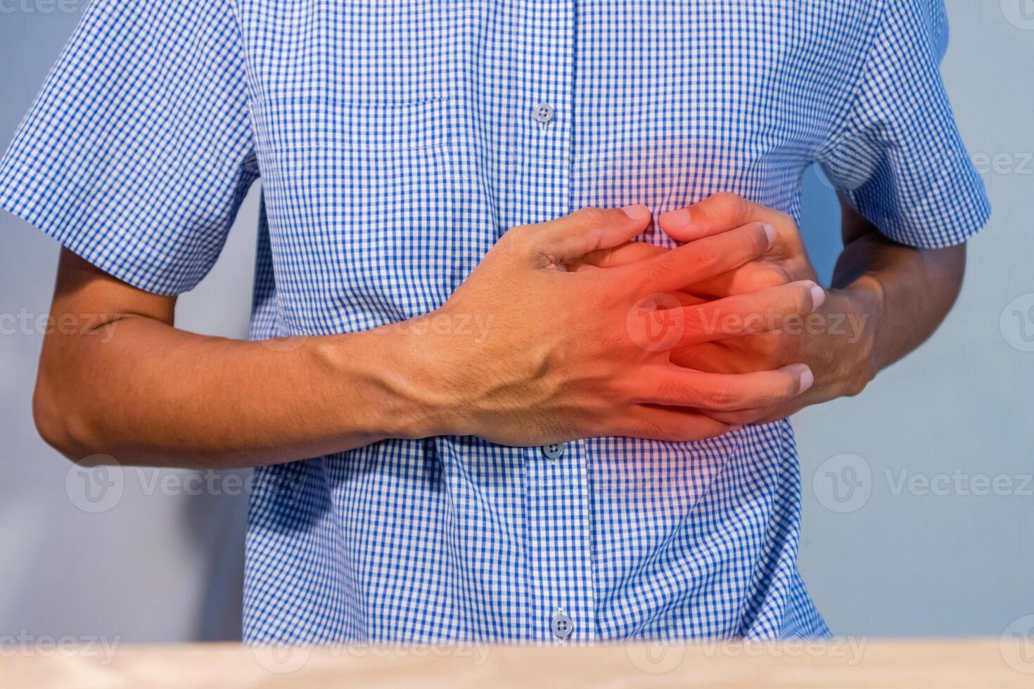 Man pressing on chest or suffering from chest pain. Heart attack symptom. photo