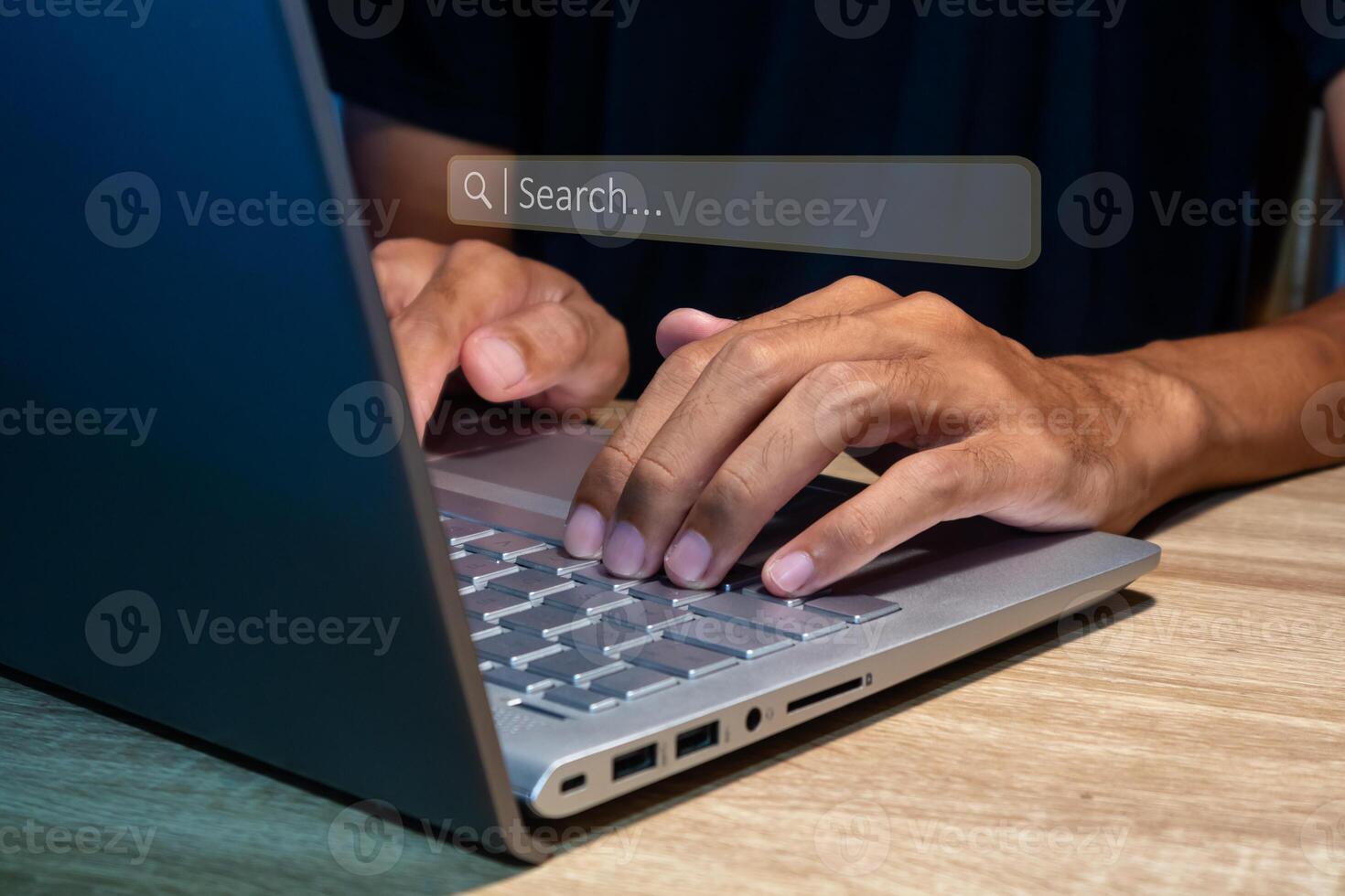 A man using a laptop to searching for information. Search engine optimization concept. photo