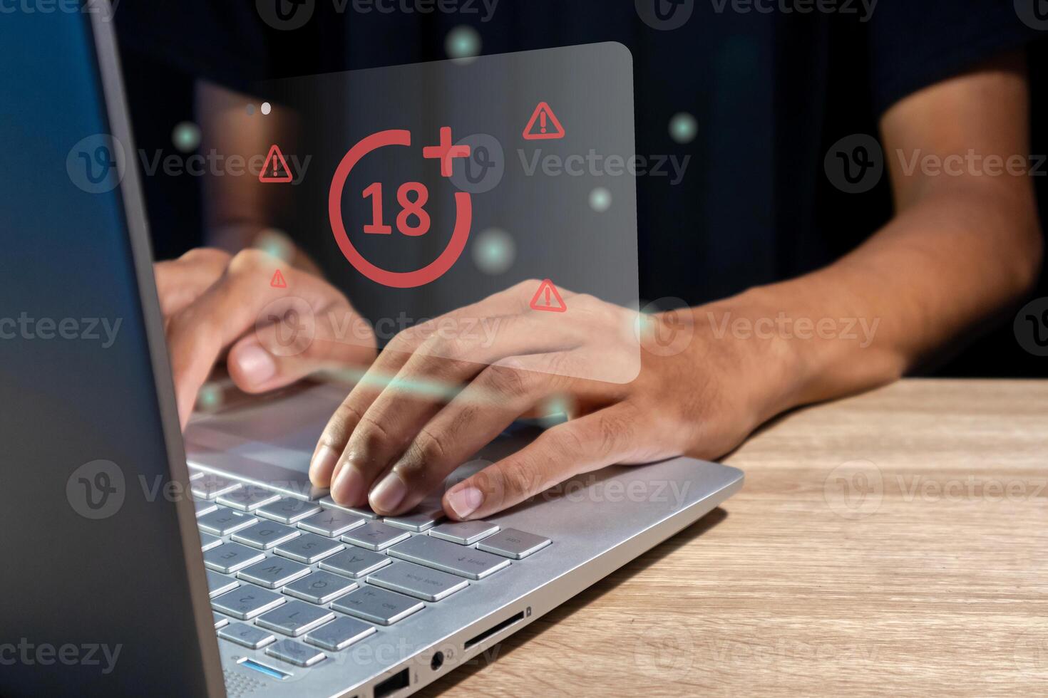 Man using laptop with restricted content icon for mature audience on virtual screen photo