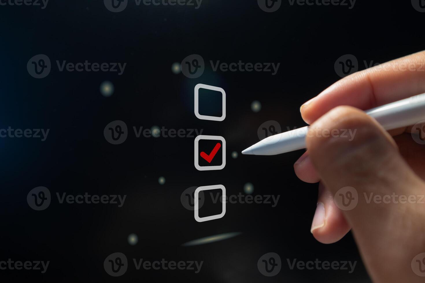 Hand holding a pen ticking a red checkmark on a box on virtual screen. Assessment, questionnaire, online survey or Business evaluation concept. photo
