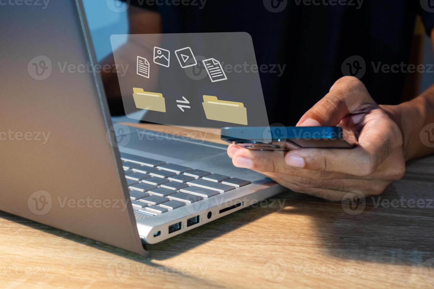 File transfer between mobile phone and laptop. Copy file and media or exchange data on virtual screen. photo