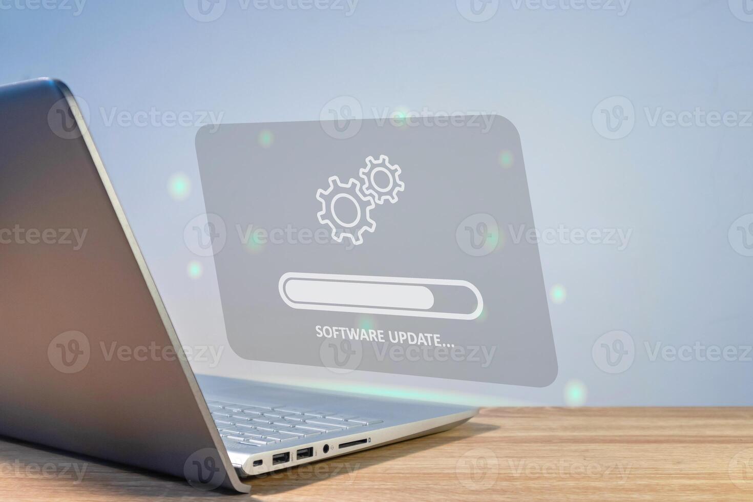 Software system update process concept. A laptop on the table with updating progress bar on virtual screen. photo