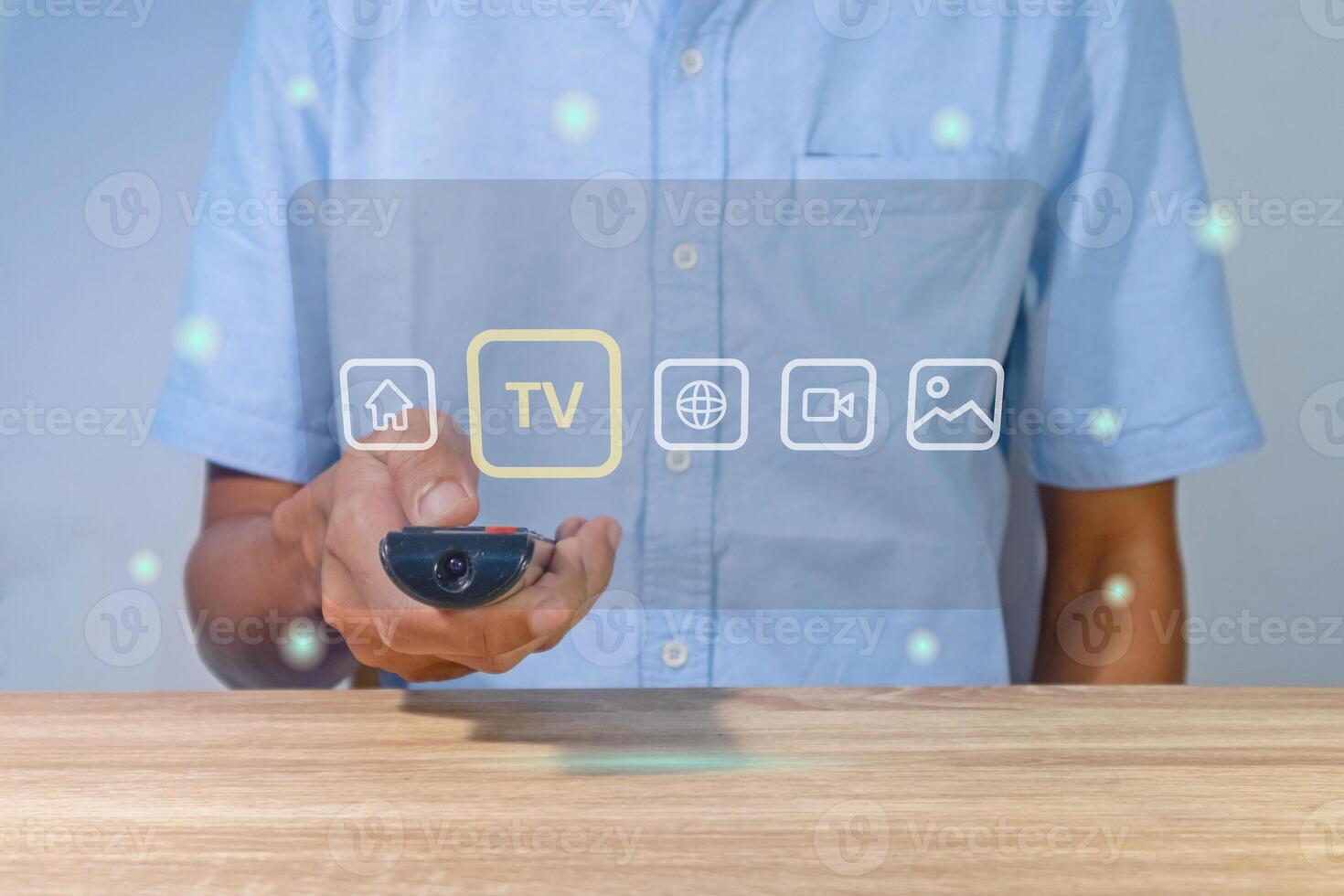 A man using a smart TV remote to change and control the entertainment menu photo