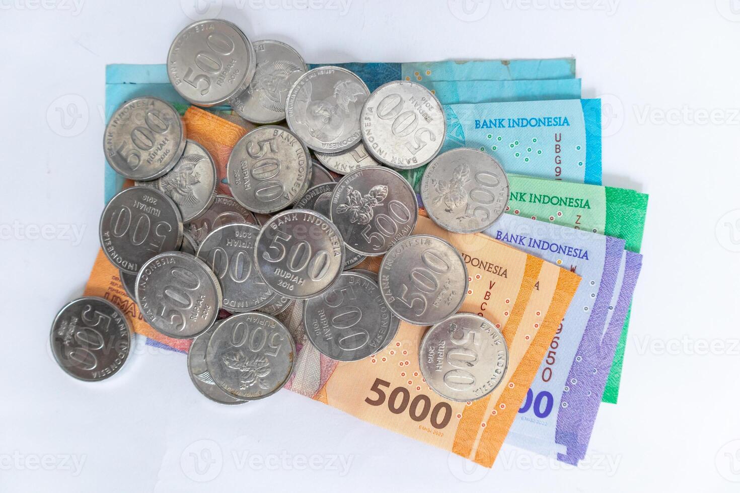 Top view of Indonesian Rupiah money and coins on a white background. Rupiah banknotes. photo
