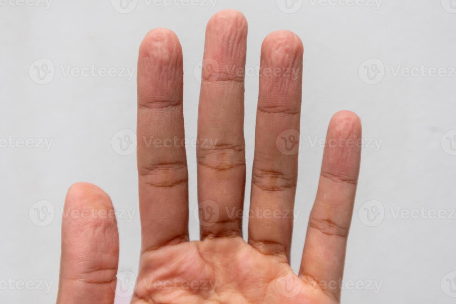 A man's wrinkled fingers because of soak in the water for a long time photo